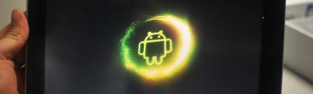 Android game featured image. Neon Android logo on a samsung galaxy tablet with sweeping circle around.